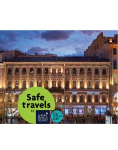 a building with a sign that reads safe travels at Nevsky Forum Hotel in Saint Petersburg