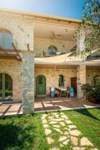 a house with a green door and a patio at Bellou Villas Sivota in Sivota