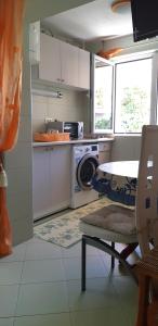 a kitchen with a washing machine and a microwave at Apartments Miljevic in Herceg-Novi
