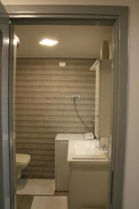 a bathroom with a sink and a toilet at Studio apartman Chiara in Zagreb