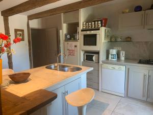 a kitchen with a sink and a counter top at La Maison De Chloe in Senouillac