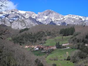 una casa en una colina con montañas nevadas en el fondo en La Posada de Viñón - Casa Reda, en Viñón 14 fotos más