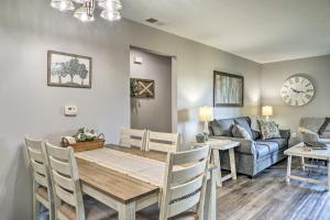 a dining room and living room with a table and a couch at Cozy Condo with Pool Access, 5 Mi to Table Rock Lake in Branson