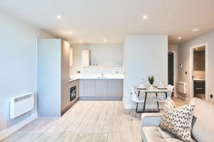 a kitchen and living room with a couch and a table at Seven Living Bracknell - Serviced Apartments in City Centre - Free Parking in Bracknell