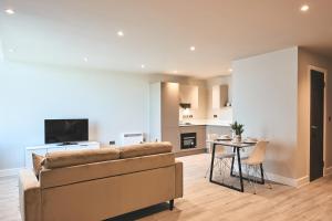 a living room with a couch and a table at Seven Living Bracknell - Serviced Apartments in City Centre - Free Parking in Bracknell