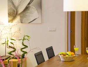 
a table topped with a laptop and a bowl of fruit at The Residences At Mar Menor Golf & Resort in Torre-Pacheco
