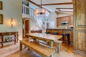 a kitchen with a wooden table and a dining room at Mountain-View Vail Condo with Balcony and Gas Grill! in Vail