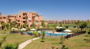 
a beach with palm trees and palm trees at The Residences At Mar Menor Golf & Resort in Torre-Pacheco
