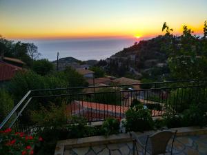 a sunset from the balcony of a house at Plagia's Sunset Apartments in Exanthia