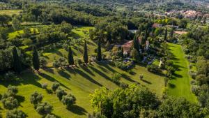 an aerial view of a house in a field with trees at Borgo il Mezzanino in Salò
