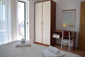 a bedroom with a bed with a desk and a window at Lina Vranković Apartments in Hvar +125 photos