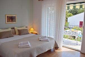 a bedroom with a bed with two towels on it at Lina Vranković Apartments in Hvar