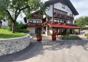 a building with flower pots on the front of it at Žigon Bed & Breakfast in Logatec