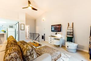 a living room with a couch and a tv at Forest Creek 26 in Mammoth Lakes