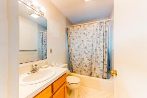 a bathroom with a sink and a toilet at Relaxing Cape Getaway in Brewster +17 photos
