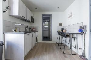a kitchen with white cabinets and a counter top at Cute Affordable 1-Br Minutes From Cannes Center in Cannes