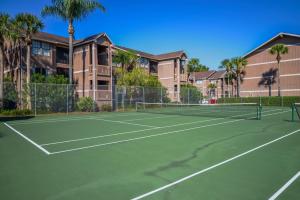 a tennis court with a tennis racket on it at Polynesian Isles Resort By Diamond Resorts - Newly Renovated in Kissimmee