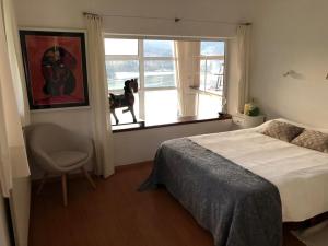 a bedroom with a bed and a chair and a window at Kizkitza in Gautegiz Arteaga