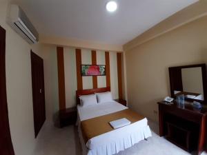 Ein Bett oder Betten in einem Zimmer der Unterkunft Hotel El Andino