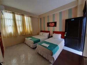 Ein Bett oder Betten in einem Zimmer der Unterkunft Hotel El Andino