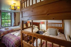 a bedroom with two bunk beds in a room at The Falls Of Dochart Inn in Killin