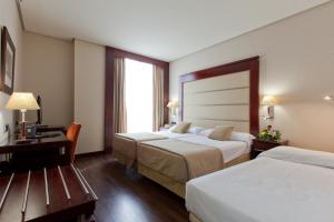 a hotel room with two beds and a window at Hotel Valencia Center in Valencia