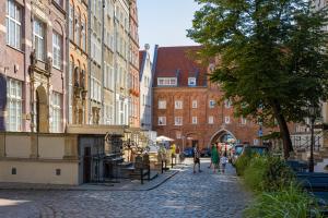 une rue pavée dans une ville avec des bâtiments dans l'établissement Apartament Brama Chlebnicka, à Gdańsk