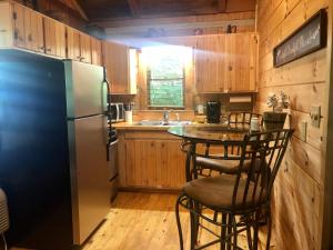 a kitchen with a refrigerator and a table with chairs at Bearadise in Townsend