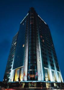 a tall building with glass windows at night at Grand Fiesta Americana Chapultepec in Mexico City