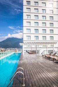 a hotel with a swimming pool next to a building at Fiesta Inn Monterrey Tecnologico in Monterrey