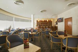 a restaurant with chairs and tables in a room at Fiesta Inn Mexicali in Mexicali