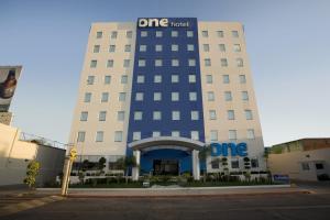 a one hotel building with a sign on it at One Aguascalientes San Marcos in Aguascalientes