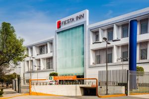 a building with a sign in front of it at Fiesta Inn Plaza Central Aeropuerto in Mexico City