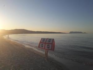 um sinal de stop na praia perto da água em Appartamento Ottiolu Mare em Porto Ottiolu