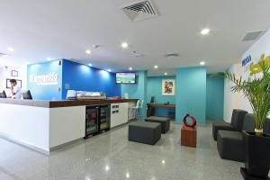 a lobby of a pharmacy with a blue wall at One Guadalajara Periferico Poniente in Guadalajara