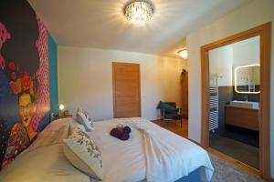 a bedroom with a bed with a teddy bear on it at Design Residence Del Passo in Padola