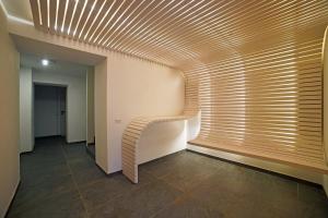 a hallway with a wooden spiral stair in a building at Design Residence Del Passo in Padola