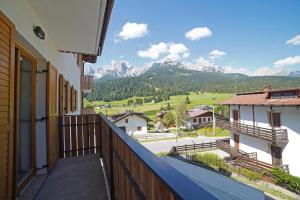 a balcony with a view of the mountains at Design Residence Del Passo in Padola