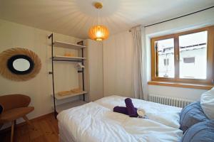 a small bedroom with a bed and a window at Design Residence Del Passo in Padola