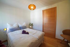 a bedroom with a bed with a teddy bear on it at Design Residence Del Passo in Padola