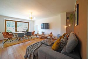 a living room with a couch with two dogs on it at Design Residence Del Passo in Padola