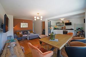 a living room with a table and chairs at Design Residence Del Passo in Padola