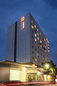 a tall building with cars parked in front of it at Fiesta Inn Express Monterrey Centro in Monterrey