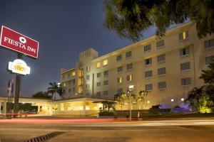 a hotel building with a street sign in front of it at Fiesta Inn Ciudad del Carmen in Ciudad del Carmen