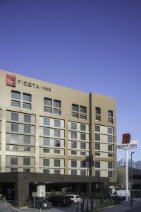 a hotel with a sign on the front of a building at Fiesta Inn Monterrey Valle in Monterrey