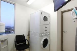 a washer and dryer in a room with a chair at One La Paz in La Paz