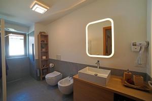 a bathroom with a sink and a mirror at Design Residence Del Passo in Padola +37 photos