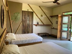 A bed or beds in a room at Villas Adriana, Palenque