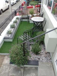 a patio with a table and chairs on a balcony at Westfield House in Blackpool