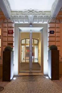 a large room with a large door and a large mirror at Red & Blue Design Hotel Prague in Prague